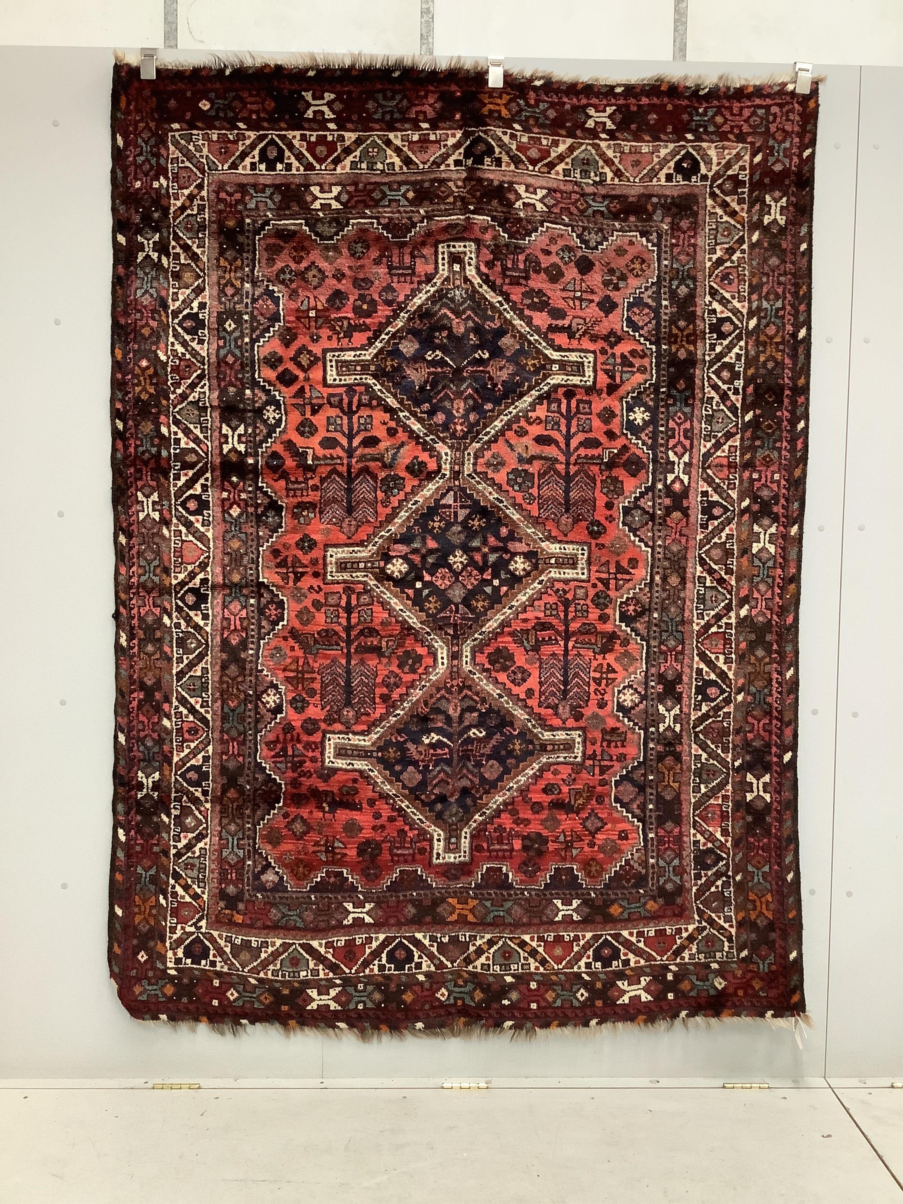 A Qashqai brick red ground rug, 216 x 160cm. Condition - fair to good